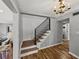 Entryway featuring hardwood floors, chandelier, stairway and view into the living room at 17515 Drake Ct, Lutz, FL 33559