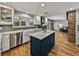 Modern kitchen with stainless steel appliances, a center island, and seamless flow to the living area at 17515 Drake Ct, Lutz, FL 33559