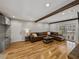 Inviting living room with hardwood floors, a brown leather sectional, and a brick fireplace at 17515 Drake Ct, Lutz, FL 33559