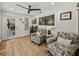 Cozy sitting room with floral armchairs, natural light, and a jute rug at 17515 Drake Ct, Lutz, FL 33559