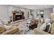 Cozy living room with a brick fireplace, comfortable seating, and natural light at 17515 Drake Ct, Lutz, FL 33559