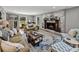 Inviting living room with a brick fireplace, hardwood floors, and comfortable seating at 17515 Drake Ct, Lutz, FL 33559