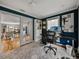 Well-lit office space with views to the living room, showcasing a functional workspace in a home at 17515 Drake Ct, Lutz, FL 33559