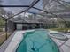 Screened pool and patio featuring a dining area, seating area, and sparkling swimming pool at 17515 Drake Ct, Lutz, FL 33559