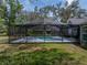 Inviting screened-in pool and spa with ample seating, perfect for relaxation and entertainment at 17515 Drake Ct, Lutz, FL 33559