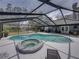 Screened pool and patio featuring a dining area, seating area, and sparkling swimming pool at 17515 Drake Ct, Lutz, FL 33559