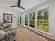 Bright sunroom featuring hardwood floors, neutral walls, and multiple windows providing natural light and views of the outdoors at 17515 Drake Ct, Lutz, FL 33559