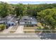 Aerial view of home with expansive driveway nestled among many trees at 17815 Cranbrook Dr, Lutz, FL 33549