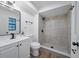 Modern bathroom showcasing a tiled shower, a white vanity and contemporary fixtures at 17815 Cranbrook Dr, Lutz, FL 33549