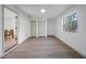 Bright bedroom with hardwood floors, two closets, and large window with lush outdoor views at 17815 Cranbrook Dr, Lutz, FL 33549