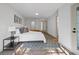 Well lit bedroom featuring a bed, area rug, white walls and laminate flooring at 17815 Cranbrook Dr, Lutz, FL 33549