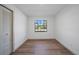 Cozy room with laminate flooring, white walls, and a window offering natural light at 17815 Cranbrook Dr, Lutz, FL 33549