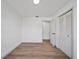 A bright room with laminate flooring and an open closet with a view to another room at 17815 Cranbrook Dr, Lutz, FL 33549