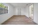 Spacious bedroom with hardwood floors, large window, and an open view to the outdoors at 17815 Cranbrook Dr, Lutz, FL 33549