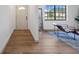 Welcoming entryway with hardwood floors, a view into the bright living space, and a stylish mirror at 17815 Cranbrook Dr, Lutz, FL 33549