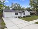 Charming one-story home with a well-manicured lawn, concrete driveway, and attached one car garage at 17815 Cranbrook Dr, Lutz, FL 33549