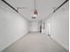 Spacious garage with white painted block walls, a bright interior, and a service door at 17815 Cranbrook Dr, Lutz, FL 33549