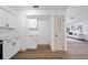 Bright kitchen area with white cabinets, hardwood floors, and an open view to the living room at 17815 Cranbrook Dr, Lutz, FL 33549