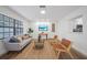 Comfortable living room with stylish seating, modern decor, and a view of the updated kitchen at 17815 Cranbrook Dr, Lutz, FL 33549