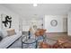Spacious living area with modern décor and hardwood flooring leading to the dining area at 17815 Cranbrook Dr, Lutz, FL 33549