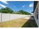 A well-maintained backyard features a privacy fence, lawn, and small stone patio at 1873 Colding Dr, Ruskin, FL 33570