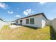 A quaint backyard with a small stone patio and well maintained lawn at 1873 Colding Dr, Ruskin, FL 33570