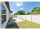 The grassy backyard features a privacy fence and small stone patio at 1873 Colding Dr, Ruskin, FL 33570