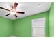 Bright green bedroom with a ceiling fan and window at 1873 Colding Dr, Ruskin, FL 33570