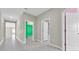 Hallway with tile floors leads to a green bedroom at 1873 Colding Dr, Ruskin, FL 33570