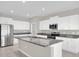 Bright kitchen features an island, stainless steel appliances, and tile floors at 1873 Colding Dr, Ruskin, FL 33570