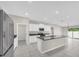 Bright kitchen featuring modern appliances, white cabinets and a granite topped island at 1873 Colding Dr, Ruskin, FL 33570