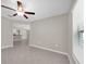 Bright living room features neutral paint, tile floors, a ceiling fan, and great natural light at 1873 Colding Dr, Ruskin, FL 33570