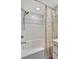 Bathroom featuring a tub with a gold shower head, white subway tile and a decorative shower curtain at 2411 W Horatio St # 526, Tampa, FL 33609