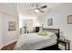 Bedroom featuring a bed with white linen, dark wood floors, a ceiling fan, and a window at 2411 W Horatio St # 526, Tampa, FL 33609