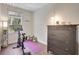 Bedroom featuring a Peloton exercise bike, a window, a lamp, and a wood floor at 2411 W Horatio St # 526, Tampa, FL 33609
