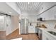 Bright kitchen features stainless steel appliances, sleek white cabinets, a stylish backsplash, and modern lighting at 2411 W Horatio St # 526, Tampa, FL 33609