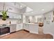 Modern kitchen featuring white cabinets, stainless steel appliances, and a breakfast bar open to the living area at 2411 W Horatio St # 526, Tampa, FL 33609