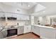 Bright kitchen with white cabinets, stainless steel appliances, and breakfast bar open to living area at 2411 W Horatio St # 526, Tampa, FL 33609