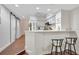 Open kitchen with barstool seating featuring white cabinets, stainless steel appliances, and a charming tiled backsplash at 2411 W Horatio St # 526, Tampa, FL 33609