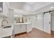 Open kitchen view showing white cabinets, marble countertops, and barn door entry to the bedroom at 2411 W Horatio St # 526, Tampa, FL 33609