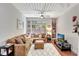 Living room featuring a large sectional sofa, plush rug, and well-lit entertainment area at 2411 W Horatio St # 526, Tampa, FL 33609