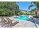 Large outdoor pool offering a refreshing escape, complemented by lounge chairs and palm trees at 2411 W Horatio St # 526, Tampa, FL 33609