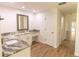 Bathroom with marble counters, vanity, and door leading to pool at 2505 Buckhorn Run Dr, Valrico, FL 33596