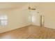 Bright bedroom boasts wood floors, ceiling fan, neutral walls, and windows offering ample natural light at 2505 Buckhorn Run Dr, Valrico, FL 33596