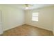Cozy bedroom featuring wood floors, ceiling fan, neutral walls, and a bright window at 2505 Buckhorn Run Dr, Valrico, FL 33596
