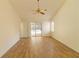 Spacious bedroom featuring wood floors, ceiling fan, and sliding glass doors leading to the pool area at 2505 Buckhorn Run Dr, Valrico, FL 33596