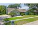 Inviting single-story home with lush green lawn, mature trees, and manicured bushes at 2505 Buckhorn Run Dr, Valrico, FL 33596