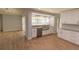 Eat in kitchen with stainless steel appliances, white cabinetry, wood floors and a large window at 2505 Buckhorn Run Dr, Valrico, FL 33596