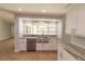 Open Kitchen with white cabinets, stainless steel appliances, wood floors and a large window at 2505 Buckhorn Run Dr, Valrico, FL 33596