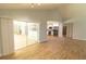 Open living room with wood floors, a sliding glass door and a view into the kitchen at 2505 Buckhorn Run Dr, Valrico, FL 33596
